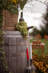 Sunflower and Grape Arrangement on Rustic Barrel in Outdoor Setting
