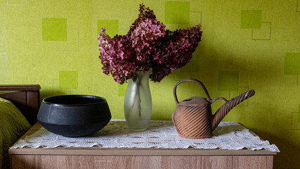still life with dried flowers and various dishes on a green background, season, leisure and objects concept