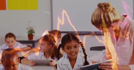 Leaning teacher assisting girl in white shirt using tablet in primary class, with graph overlay