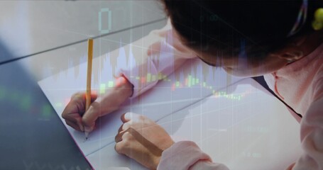 Writing child in pink longsleeve top marking spiral pad at desk with yellow pencil, chart overlay