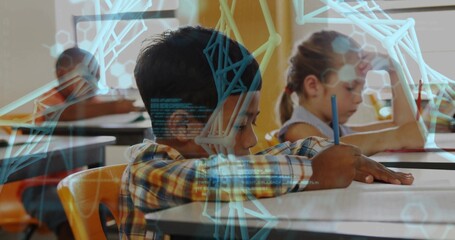 Writing boy in plaid long-sleeve shirt using pencil at school desk, with blue overlay