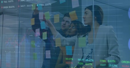 Pointing three colleagues placing post-its on glass wall in office, in blazers with charts overlaid