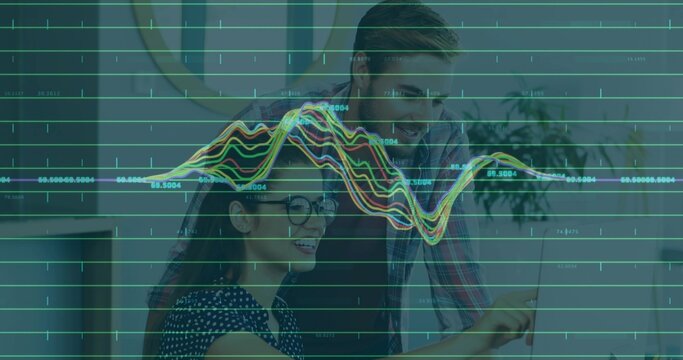 Reviewing laptop screen, pair pointing at office screen with data overlay, woman wearing polka top