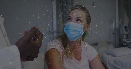 Looking up, patient wearing pink shirt, blue mask on hospital bed with doctor hand, network overlay © vectorfusionart