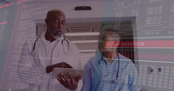 Walking doc in lab coat consulting nurse in scrubs, holding tablet in hospital, encryption banner - Powered by Adobe