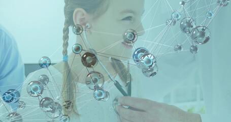 Dotted shirt child sitting in clinic having stethoscope exam from white coat doc, molecular overlay
