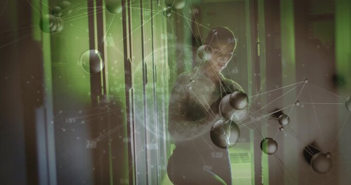 Standing mid adult female wearing fitted dark top interacting with holographic nodes in lab