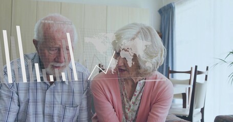 Sitting senior couple at home, wearing plaid shirt, pink cardigan, viewing data overlay with charts