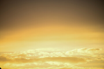 Obraz premium Sea of yellow clouds at sunset.