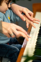 Gentle guidance musical moments little hands learn piano under watchful eyes learning to play together in a nurturing embrace of music and shared discovery at home during the daytime