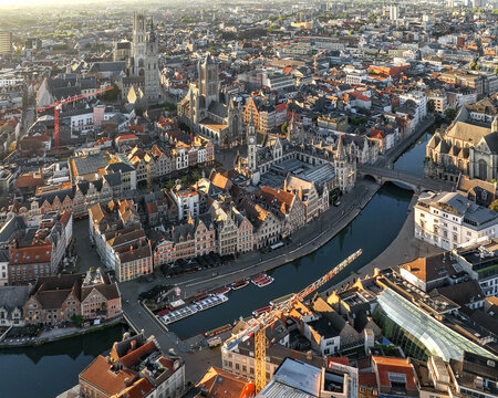 Aerial view of the Graslei and Korenlei wharves along the Leie river with reflections of the medieval architecture, St Nicholas' Church, and bridges, Ghent, Flanders, Belgium.