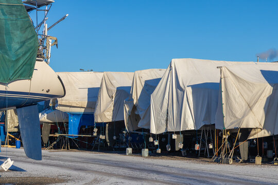 Sailboats are covered, protected and stored out of the water for the winter, winter storage for the sailboat in Finland, Suomenoja, Finnoo, winterizing