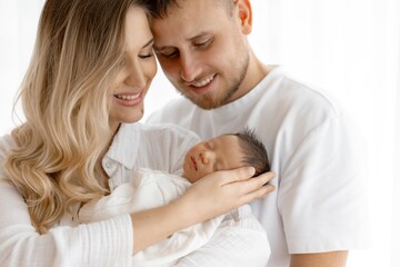 Fototapeta premium Loving Parents Adoring Newborn Baby A Portrait of Family Bliss and Tender Moments