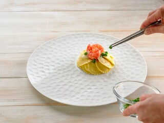An artful presentation of griasoli pasta topped with succulent shrimp and vibrant green peas captures the essence of fine dining. The careful arrangement delights the senses