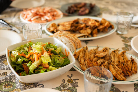 Horizontal view of the family table, homemade seafood and fish banquet, healthy recipes with fried fish from the Mediterranean diet