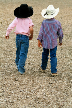 Santa Fe, New Mexico, United States. Galisteo Rodeo. Two little cowboys hang out with their big hats.
