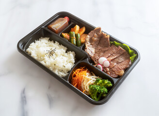 Enjoy a balanced meal with this vibrant bento box! Packed with rice, savory grilled meat, and fresh veggies, it's perfect for a quick, nutritious lunch.