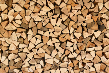Stacked firewood wall with natural wood texture