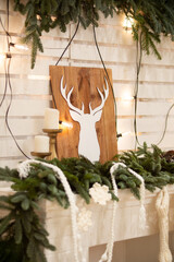 Cozy Winter Decor With Wooden Deer Silhouette and Evergreen Garland
