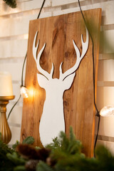 Cozy Winter Decor With Wooden Deer Silhouette and Evergreen Garland