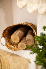 Cozy Winter Interior With Firewood in Wicker Basket by Fireplace