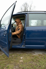 Driving through the quiet landscape with a blue van as the driver gets ready for an adventure in chilly weather on a cloudy day