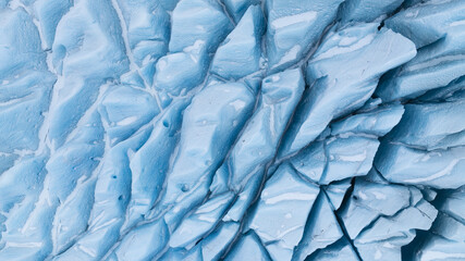 Aerial view of the icy, fractured landscape revealing a symphony of glacial blues and stark white contrasts, Jokulsarlon, Sveitarfelagid Hornafjordur, Iceland.