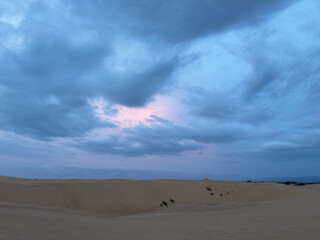 Desert Sand Dunes Landscape at Twilight with Dramatic Pink and Blue Sky