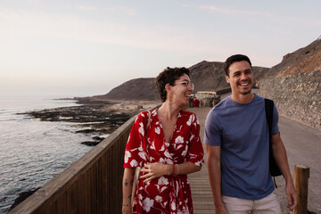 Happy couple walking along coastal path in Canary Islands