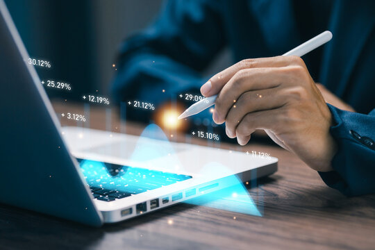 Hand using stylus to analyze floating percentage data chart on laptop, highlighting digital analytics, business metrics, performance evaluation, and financial insights in modern technology environment - Powered by Adobe