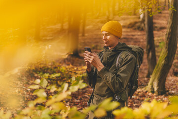 Man Hiker Using Smartphone for Navigation in Forest