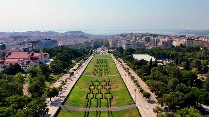 Lisbon at Sunset from Above –  Drone Flight Over Historic Rooftops, Red Palms and Oceanfront City Square. Portugal Aerial 