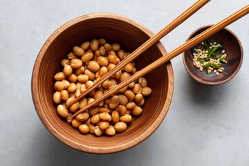 Natto soybeans with chopsticks in a wooden bowl