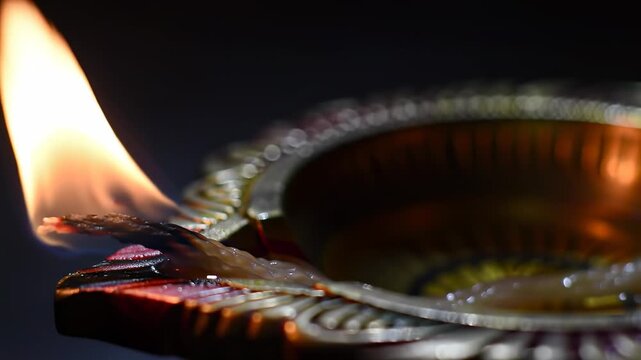 Diwali Diya Lamp Burning Flame Closeup Traditional Indian Festival Glow.