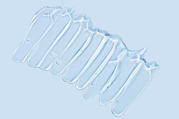 Pure transparent cosmetic gel smear on blue background, skin care glycerin texture. top view