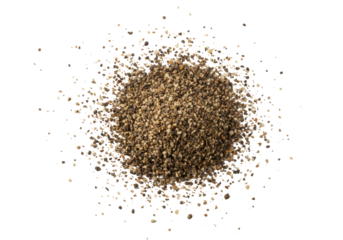 Extreme close-up macro of dark black and warm brown ground pepper particles, irregularly scattered on a pristine transparent background with copy space for text overlay, culinary ingredient concept