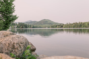 Serene lake landscape with a mountain range reflection in the water in Lake Placid, NY