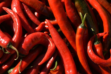 Red chili peppers, many, top-down view, vibrant color and glossy skin, vegetables and spices.