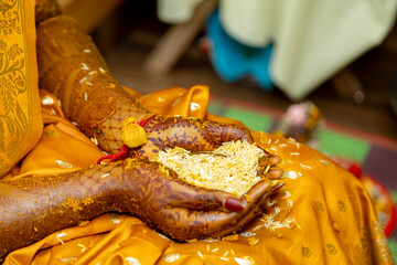 Hands of a bride during a traditional Indian wedding ceremony