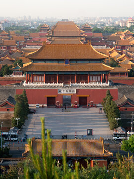 Beijing, China - 02 May 2024: View of the majestic Forbidden City, its terracotta roofs gleaming under a soft light, framed by ancient walls and distant cityscapes.