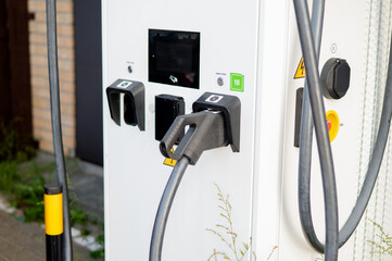 A dual-port charging station can power two electric vehicles at once, showcasing the growth of urban infrastructure for sustainable transport and the adoption of modern eco-friendly technologies