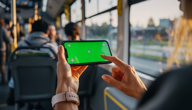 Hands woman hold use green screen phone sitting in bus touch telephone public communication vertical smartphone adult finger chroma urban cellphone application digital scrolling 
