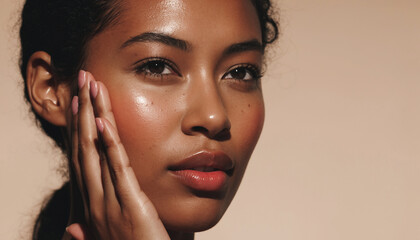 Skincare. Beautiful woman touching her healthy skin. Beautiful smiling model with natural makeup touching her radiant, moisturized skin in close-up.