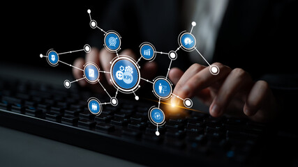 A professional hand typing on a keyboard, surrounded by visualized KPI metrics, representing data-driven decisions and performance tracking in a corporate environment. Tessel