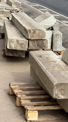 Concrete blocks arranged on wooden pallets at a construction site outdoors