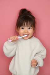 Young asian girl brushing her teeth.
