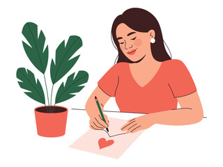Woman drawing a heart on paper with a plant in a pot on the table beside her