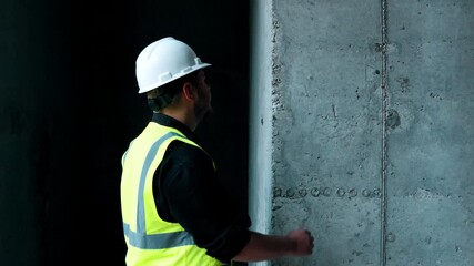 A worker is inspecting the construction site