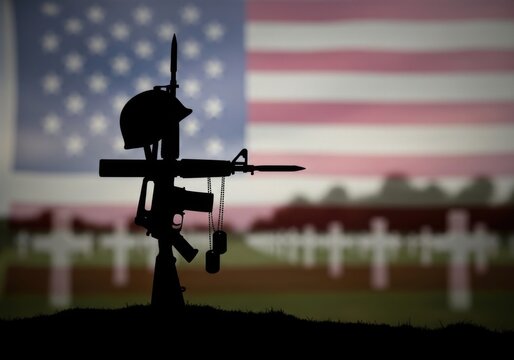 Silhouette of a fallen soldiers battle cross with rifle, helmet, and dog tags against a blurred background of an american flag and cemetery