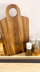 Natural wooden cutting board amid aromatic condiments, echoing rustic culinary artistry and celebration of National Cooking Day's essence